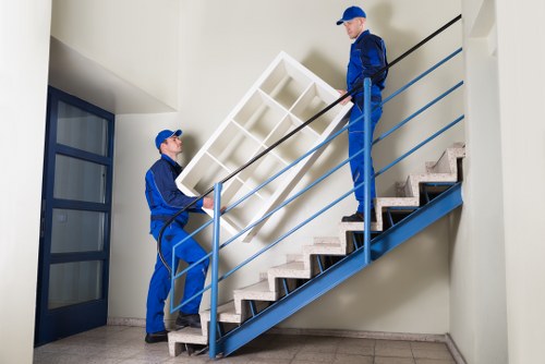 Professional movers unloading office equipment