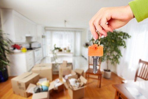 Crew wearing PPE handling office furniture with equipment